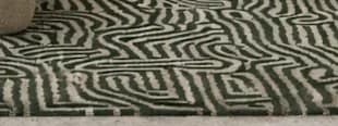 Green and cream patterned wool rug